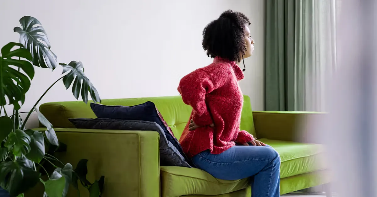 کمردرد زن روی کاناپه